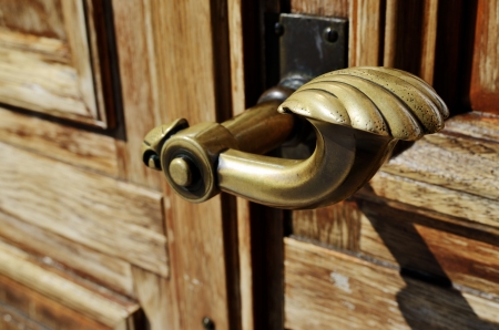 close-up of a copper doorknob and wood doorの写真素材