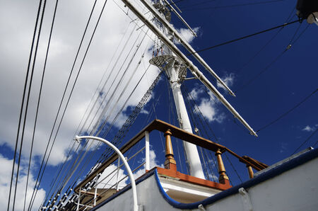 white sailboat mast on blue sky background