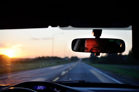 reflected in the mirror of a car driver