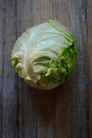 head of fresh cabbage on a wooden backgroundの写真素材