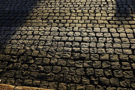 old stone pavement in the morning sunの写真素材