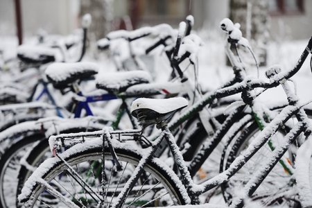 bikes covered with a blanket of snow, winter in Finlandの写真素材