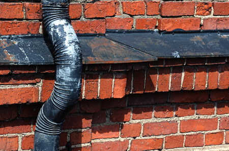 old drainpipe on a brick wall backgroundの写真素材