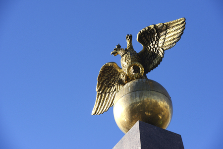 Two headed golden eagle obelisk in the market square Helsinki Finlandの写真素材