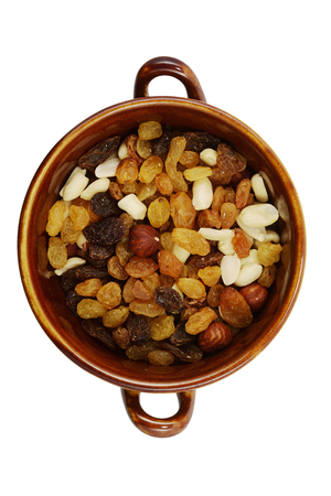 Mix of raisins and different nuts in a bowl on a white backgroundの写真素材