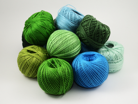 A lot of skeins of wool on a white background