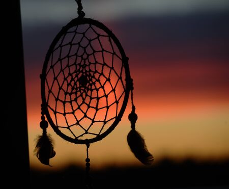 dream catcher on the background of a beautiful sunsetの写真素材