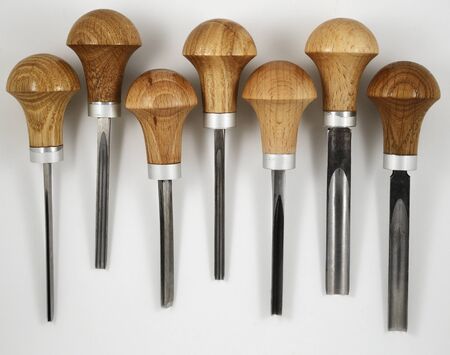 seven wood carving tools on white background
