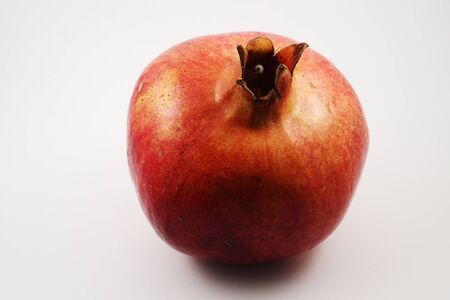 beautiful ripe red pomegranate on a white background