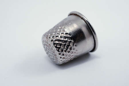 old metal tailor thimbles on a white backgroundの写真素材