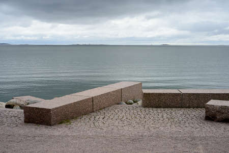 granite embankment on the shores of the Baltic Sea in Helsinki, Finland