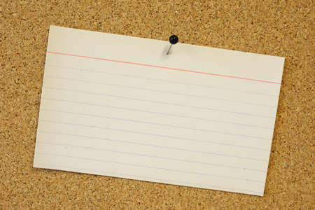 sticky note card pinned to cork board