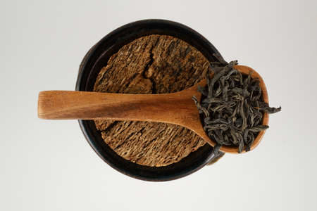 black tea leaves in a wooden spoon