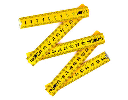yellow wooden folding rule on white background