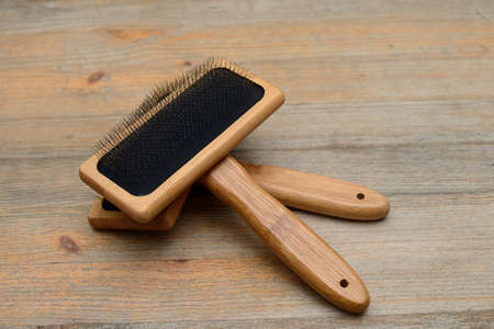 two carding brushes for combing wool on wooden background
