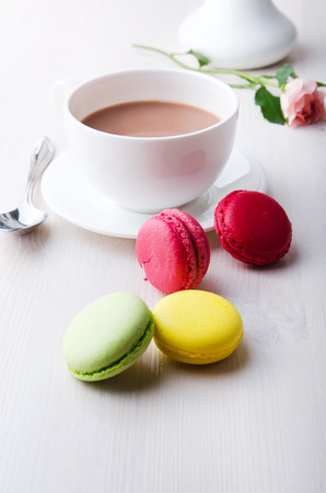 macaroons with coffee on wooden tableの写真素材