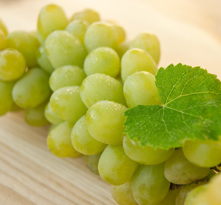 Grapes brunch on wood backgroundの写真素材