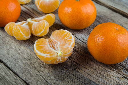 Ripe tasty tangerines on wooden の写真素材