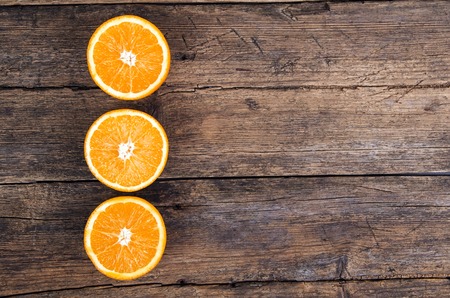 Fresh oranges on wooden backgroundの写真素材