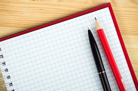 blank notebook with pen and pencil on wooden table, business conceptの写真素材