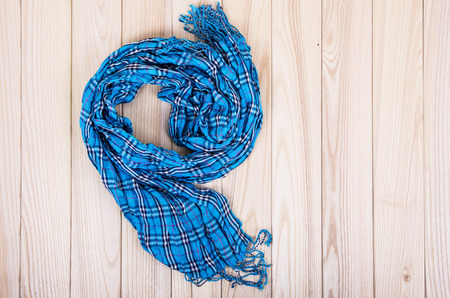 blue checkered scarf on a wooden backgroundの写真素材
