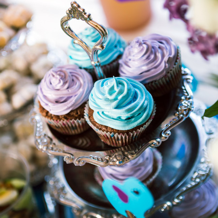 Delicious cupcakes on table on light backgroundの写真素材