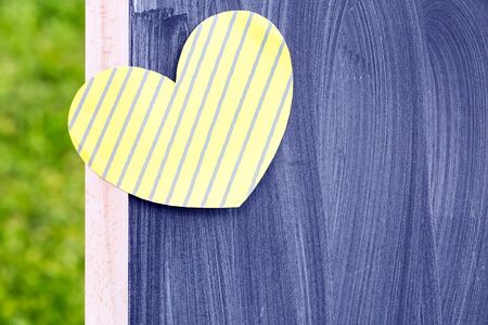 chalk board with paper heart on the grassの写真素材
