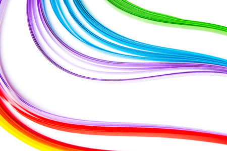 Rainbow colored quilling paper laid out in waves and shapesの写真素材