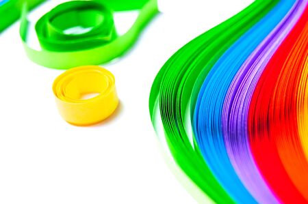 Rainbow colored quilling paper laid out in waves and shapesの写真素材
