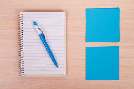 pen and paper on wooden background