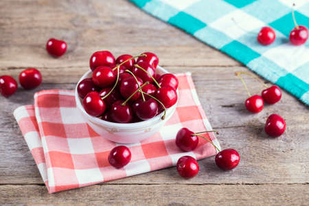 Cherries in a bowl on the table. の写真素材