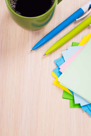 colored paper with pen and cup of coffee