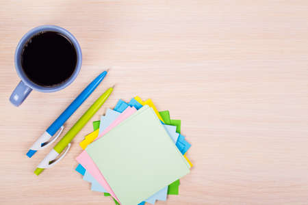 colored paper with pen and cup of coffee