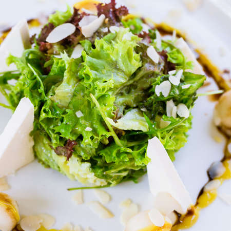 Fresh salad with arugula, pear, feta cheese, almond flakes and aioli sauceの写真素材