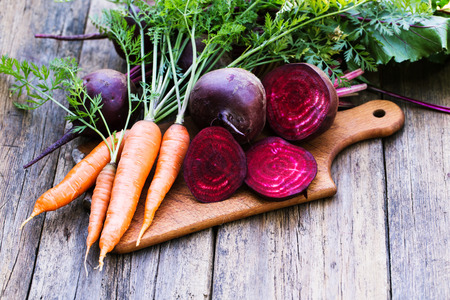 Fresh beet and carrots on wooden backgroundの写真素材