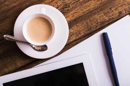 digital tablet and coffee on old wooden backgroundの写真素材