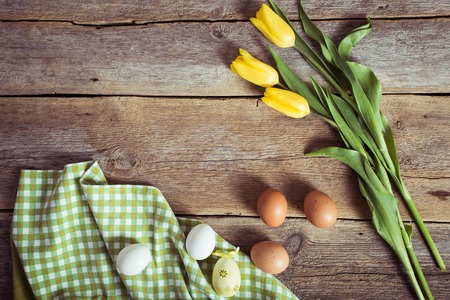 tulips and eggs on wooden background. Easter backgroundの写真素材