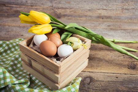 tulips and eggs on wooden background. Easter background
