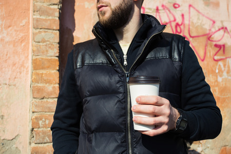 man with a cup of coffee in townの写真素材