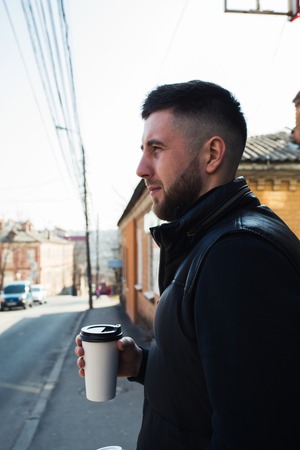 man with a cup of coffee in townの写真素材