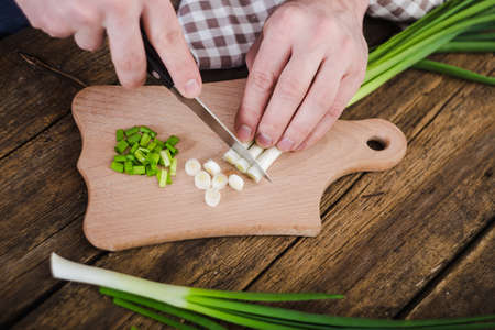 Green onions on wooden background. Cookingの写真素材