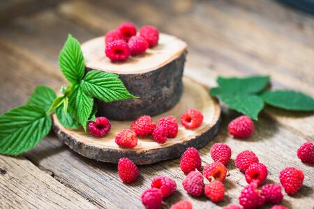 fresh raspberry on a wooden table outdoorsの写真素材