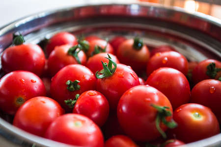 Red tomatoes background. Group of tomatoes in a plate