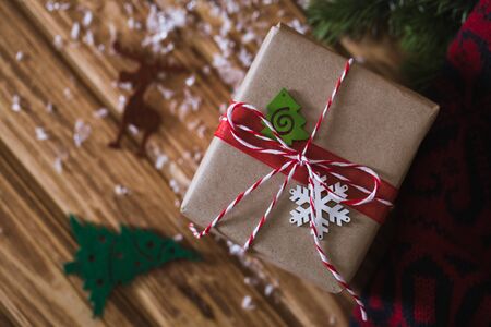 Christmas gift box with fir branches on a wooden backgroundの写真素材