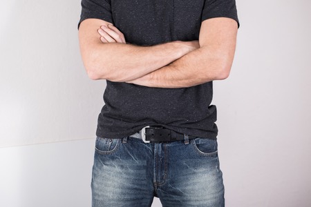 blue jeans of a young man wearing grey blank t-shirtの写真素材