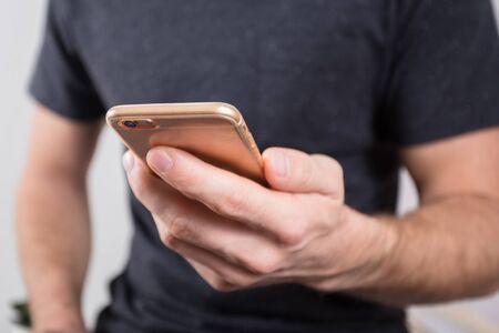 Close up of a man using mobile smart phone