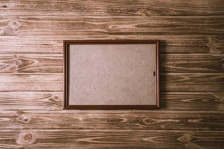 vintage photo frame on wooden board background textureの写真素材