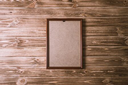 vintage photo frame on wooden board background texture