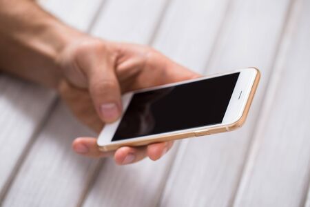 Close up of a man using mobile smart phone