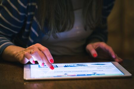 Front view of a woman using a digital tablet
